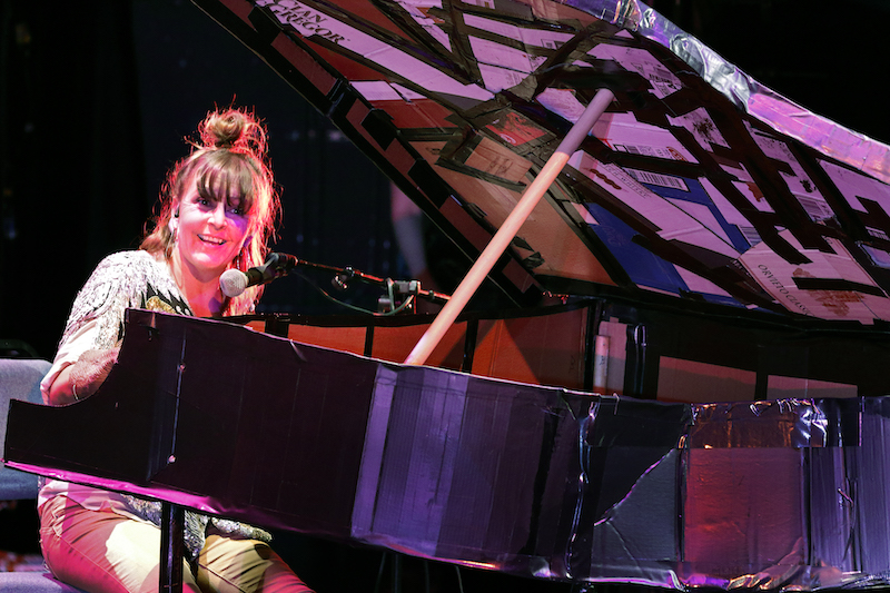 Truscott sits at her makeshift piano made of duct tape